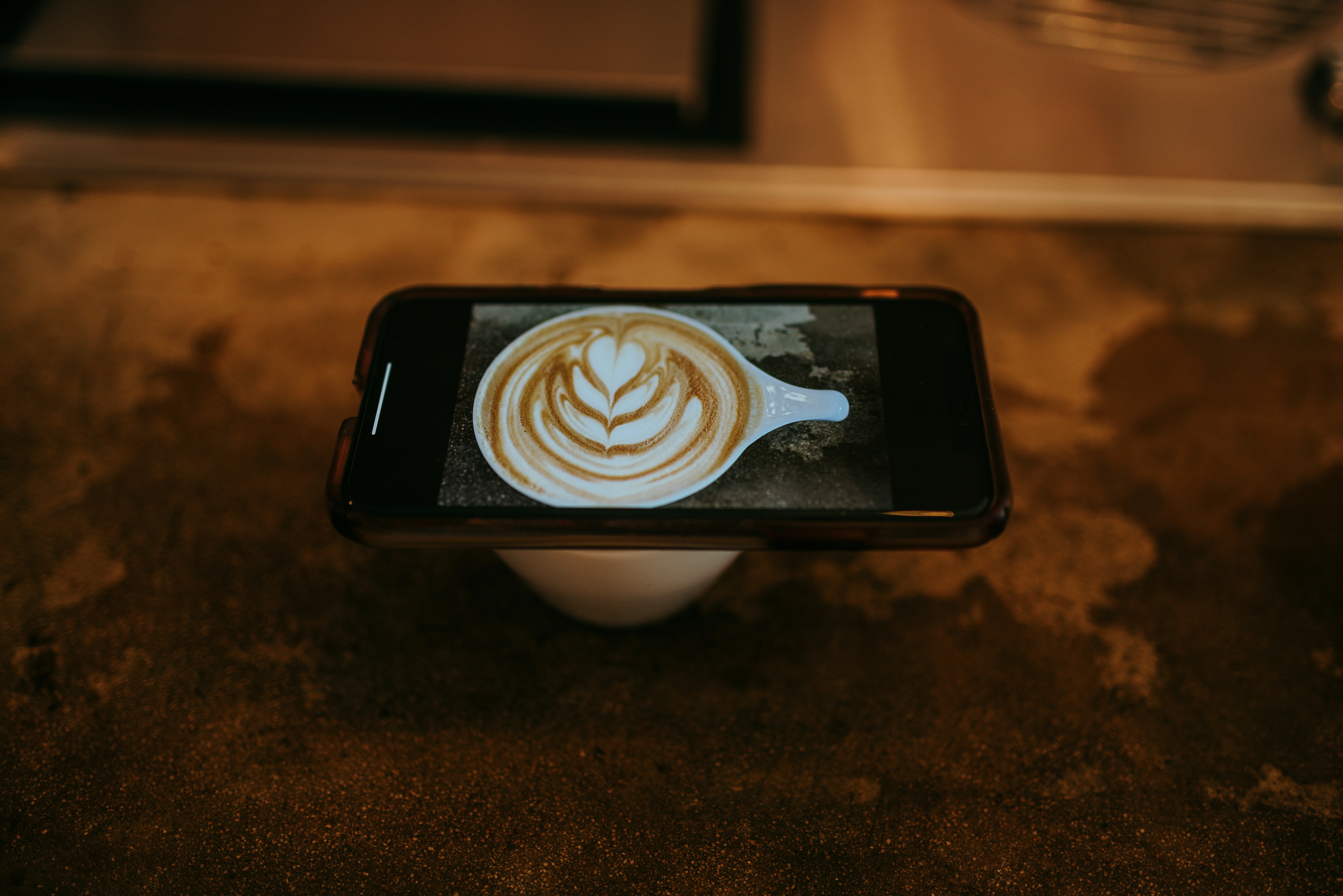white and brown heart shaped ceramic mug on black and white ceramic saucer