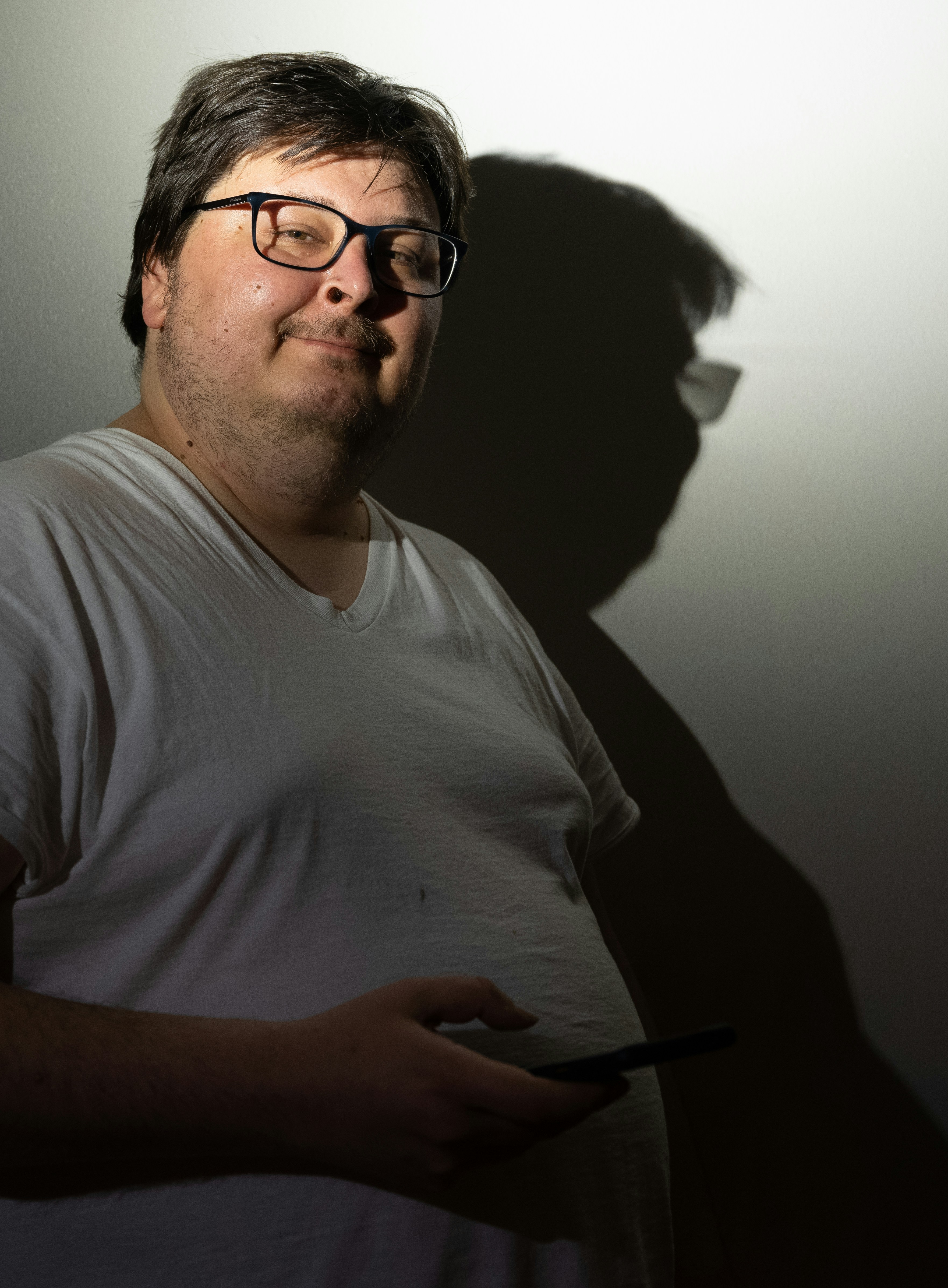 man in white crew neck t-shirt wearing black framed eyeglasses