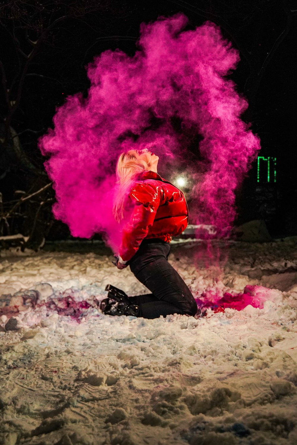 man in red jacket and black pants with pink smoke