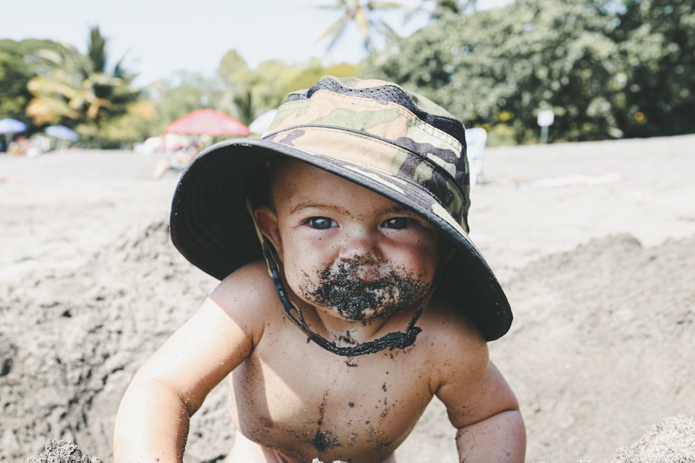 topless man wearing camouflage hat