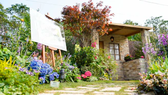A serene British cottage garden filled with colorful flowers and greenery.