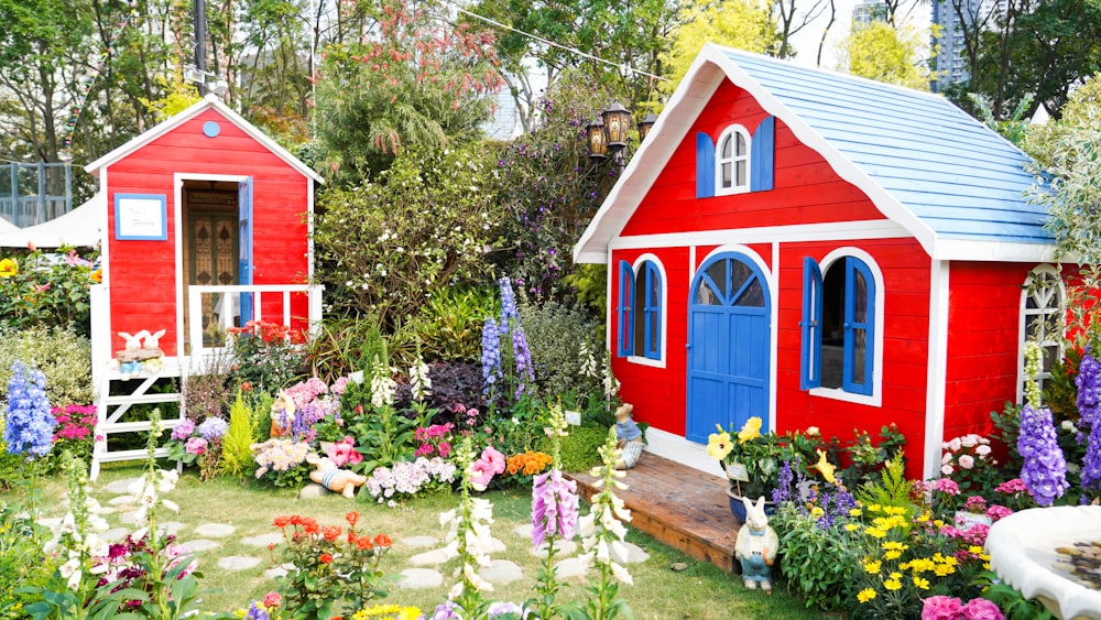 red and blue wooden house near green trees during daytime