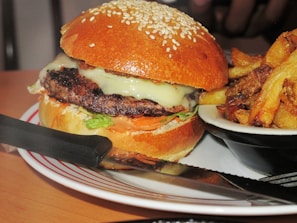 A juicy cheeseburger with melted cheese, lettuce, and tomato, served with crispy fries