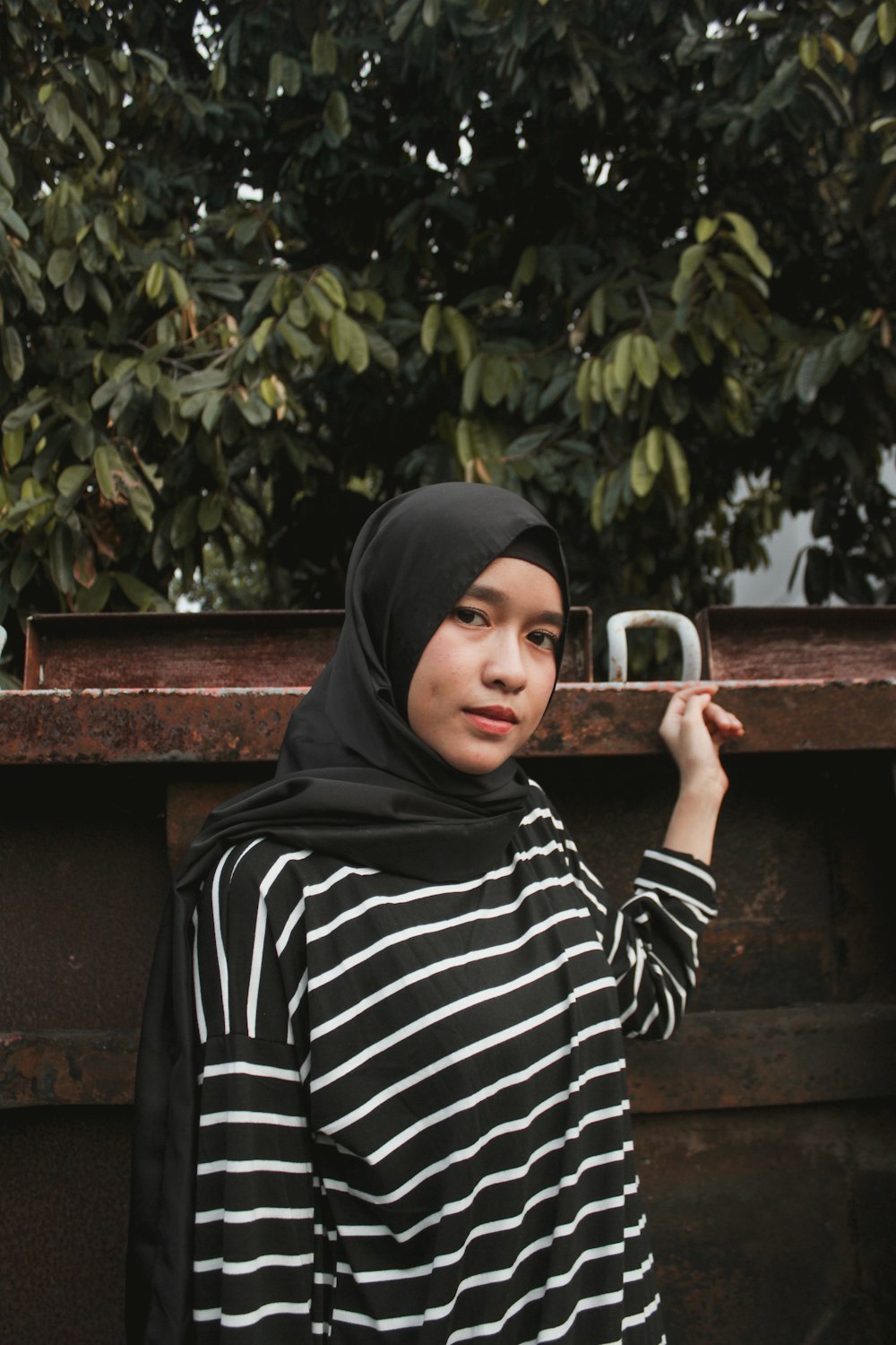 woman in black hijab and black and white stripe long sleeve shirt