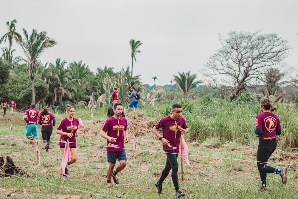 people walking on green grass field during daytime