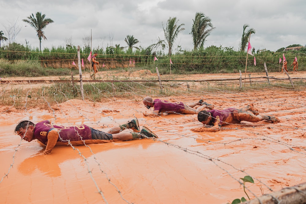 people lying on brown sand during daytime