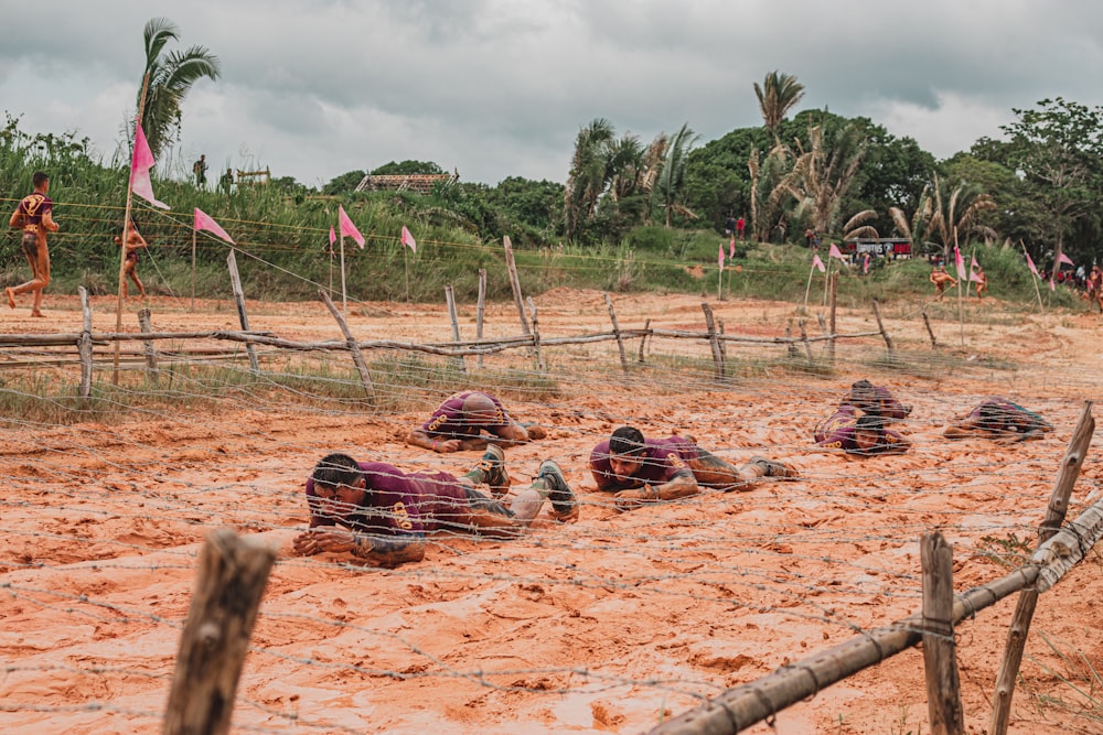 people lying on brown sand during daytime