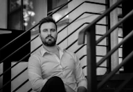 man in white dress shirt sitting on stairs
