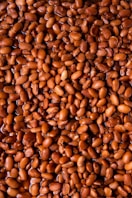 brown coffee beans on brown wooden surface