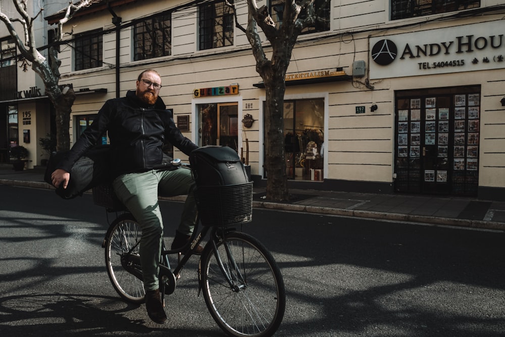 man in black jacket riding on black bicycle