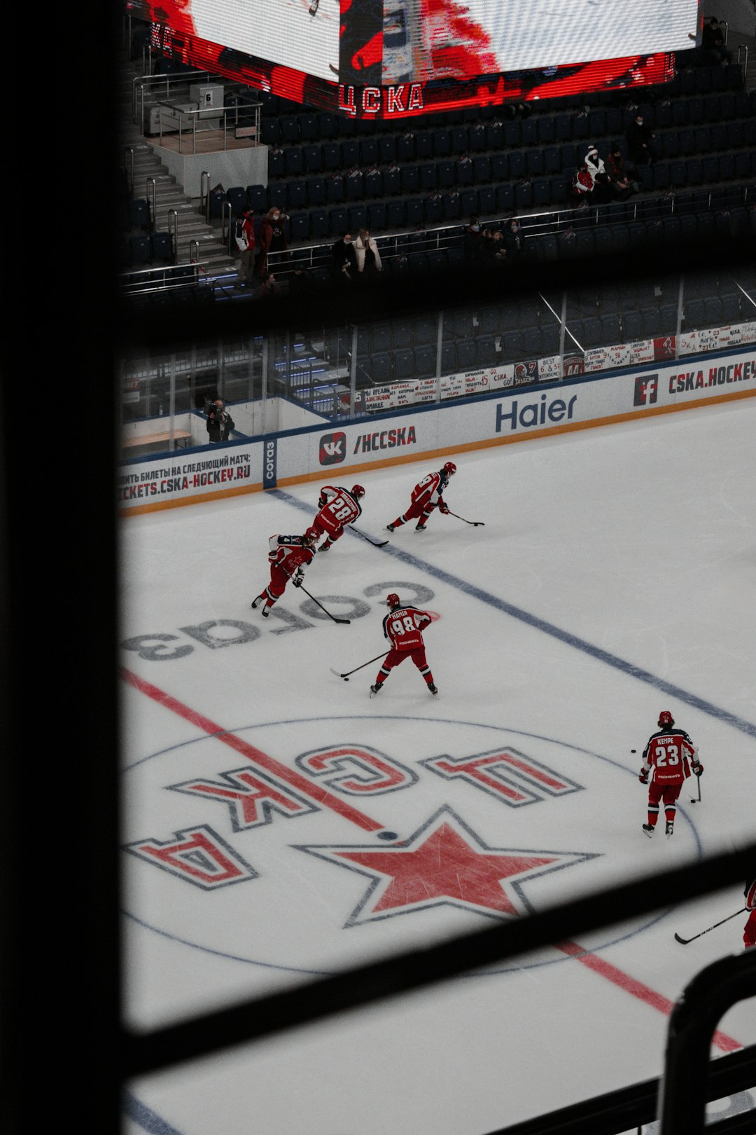 man in red jersey shirt playing ice hockey