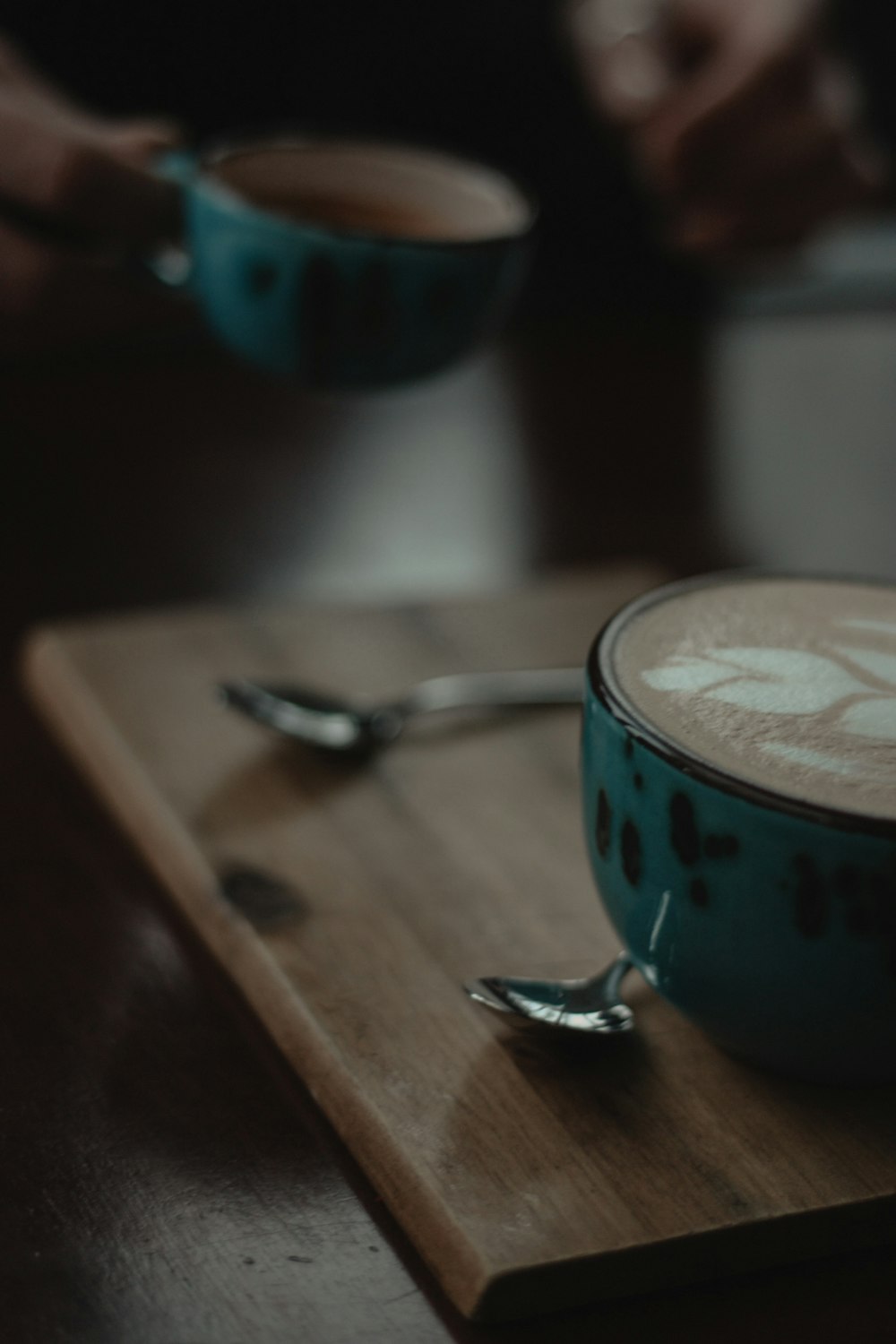 blue ceramic mug with coffee on brown wooden table