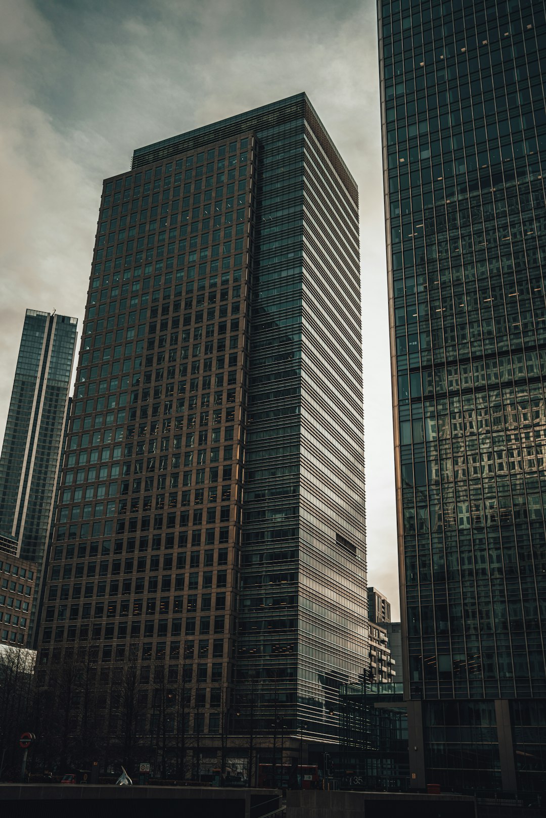 low angle photography of high rise buildings under cloudy sky during daytime
