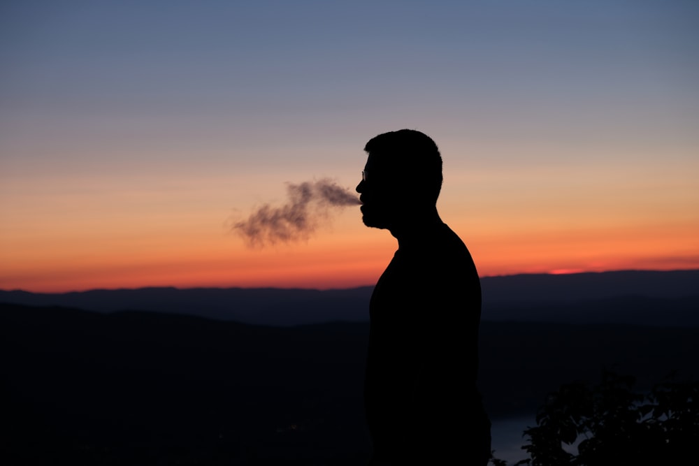silhouette of man statue during sunset