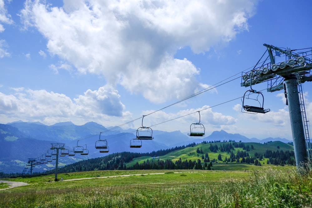 cable cars over green grass field during daytime