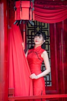 Model showcasing a sleek, modern cheongsam with subtle geometric patterns against a minimalist backdrop.