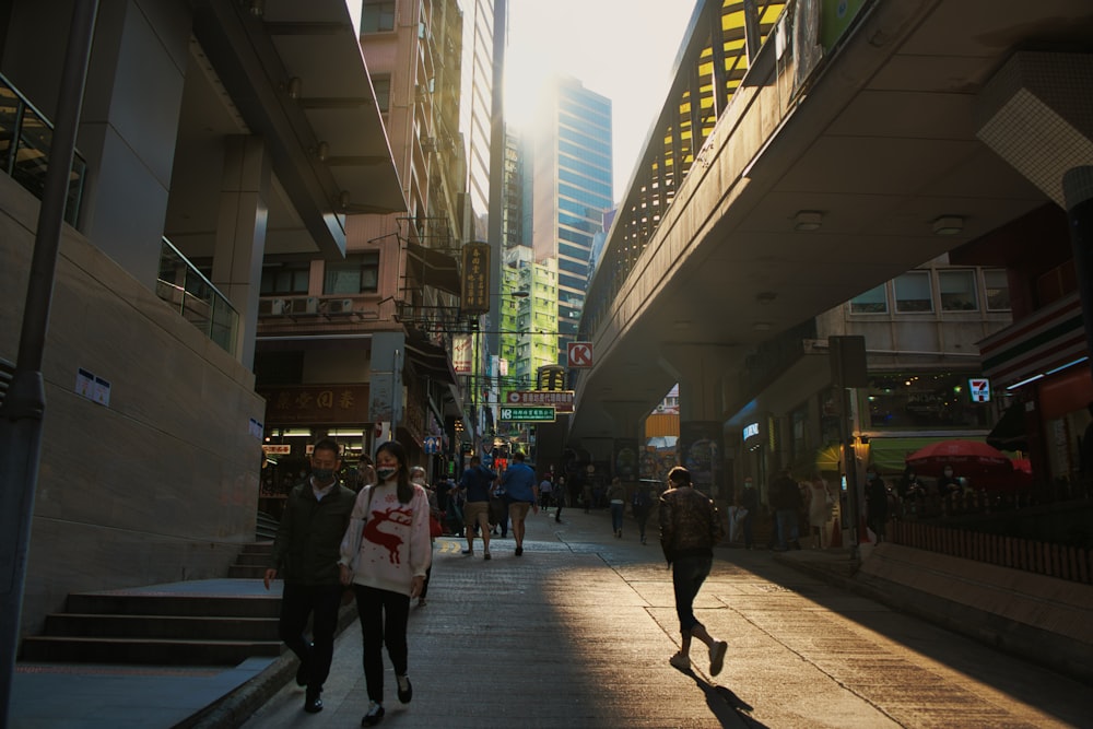 people walking on sidewalk during night time