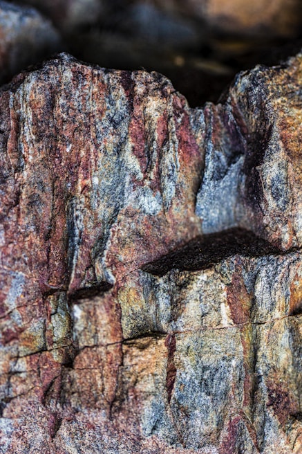 Close-up of the textured surface of one of the three stones, highlighting geological layers.