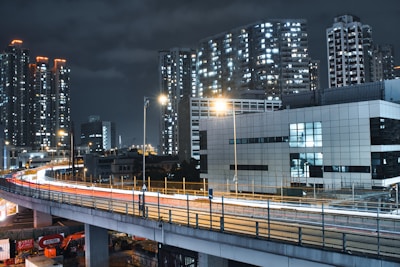 Nighttime cityscape showing illuminated commercial towers along Gurgaon’s expressway.