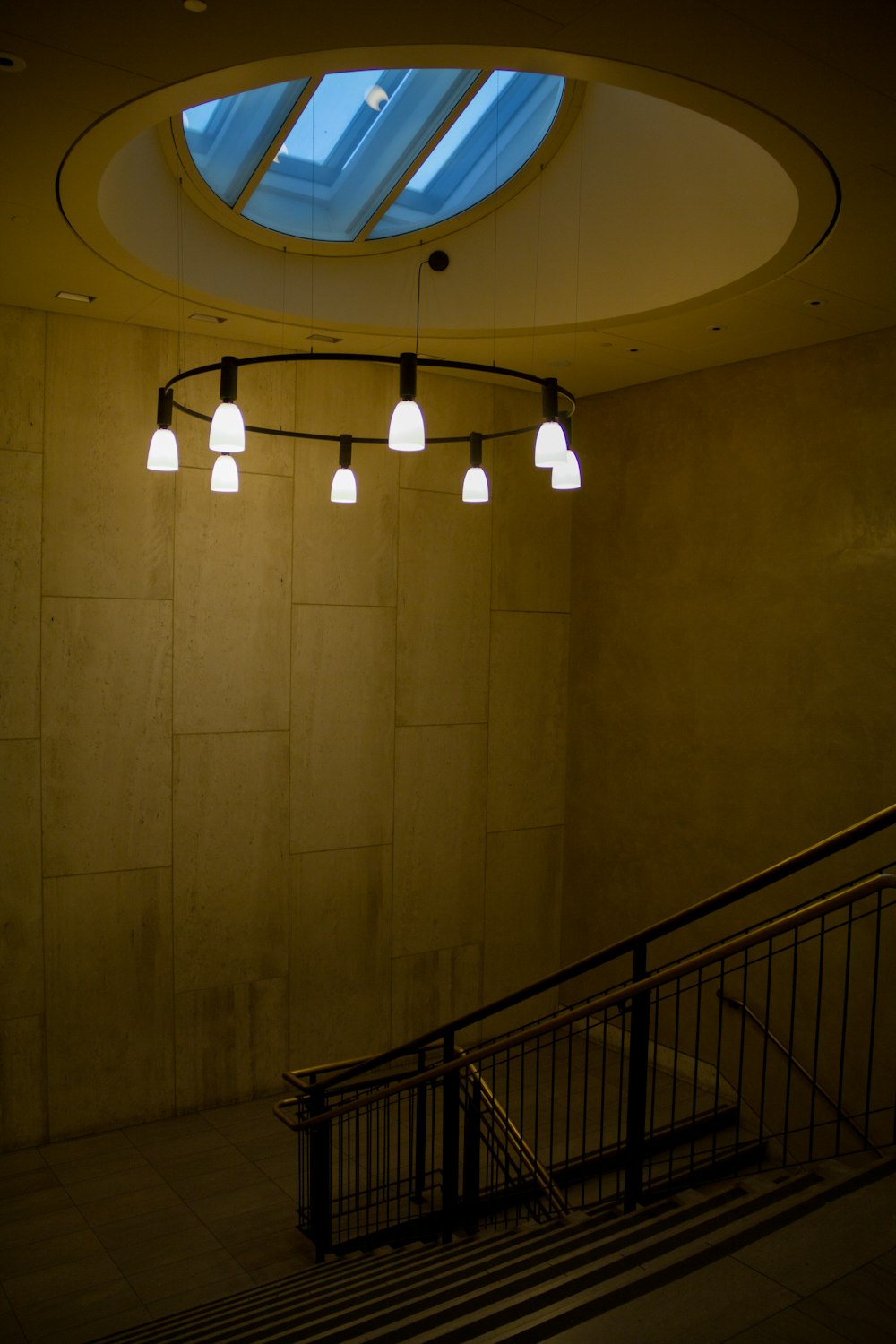 white ceiling light turned on near black metal railings