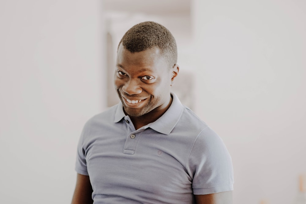 man in gray polo shirt smiling