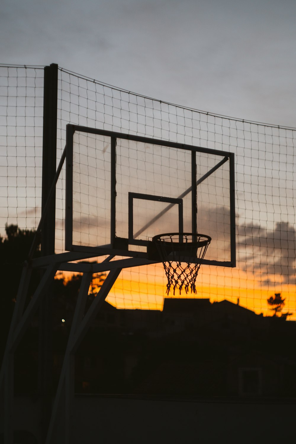 silhouette of a person sitting on a chair during sunset