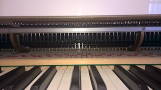 Detailed view of the internal mechanism of a piano, showcasing the hammers, strings, and keyboard in close proximity. The arrangement of mechanical components is visible, highlighting the intricate design.