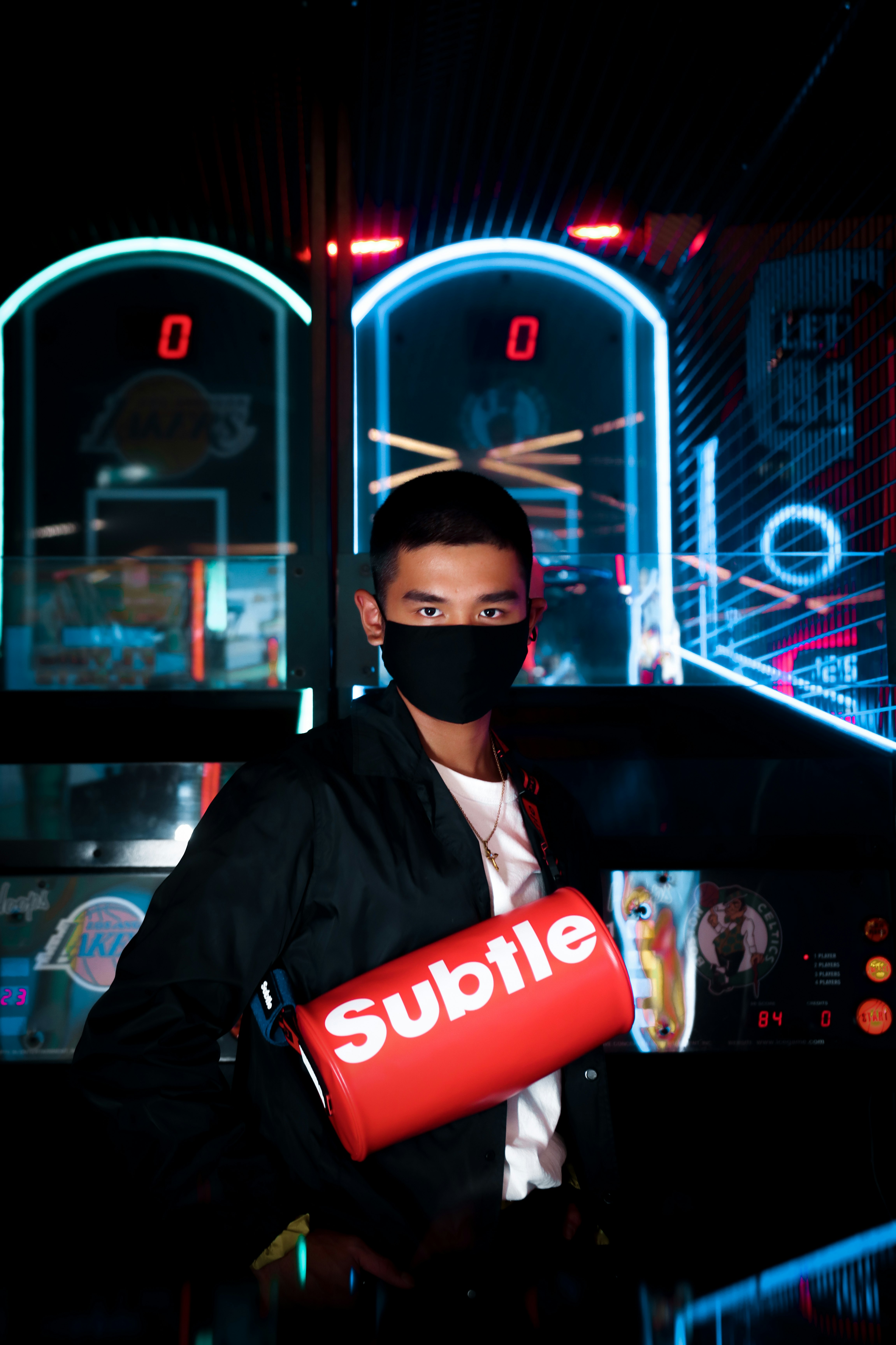 man in black jacket wearing black sunglasses holding red and white coca cola can