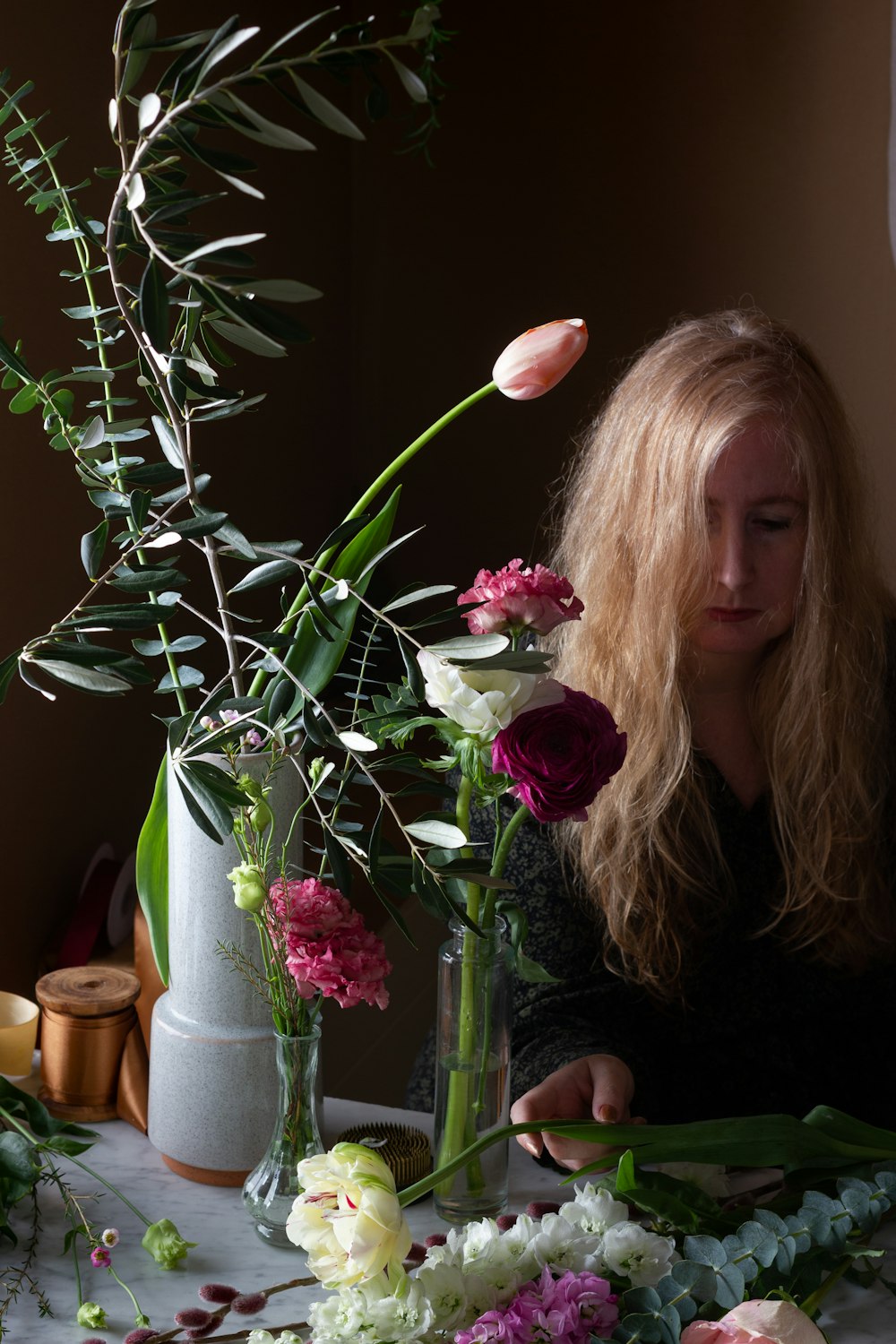 woman holding pink and white flowers