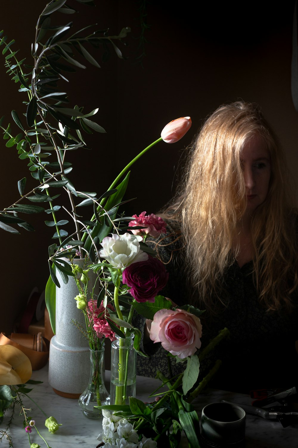 woman in black shirt holding pink rose bouquet