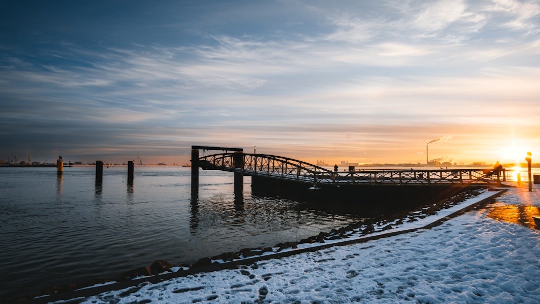 brown wooden dock on sea during sunset