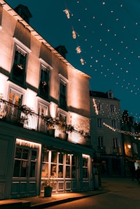 A charming boutique hotel with warm lights glowing at dusk.