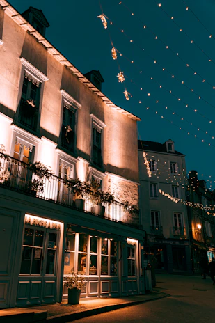 A cozy boutique hotel terrace bathed in warm golden light at dusk.