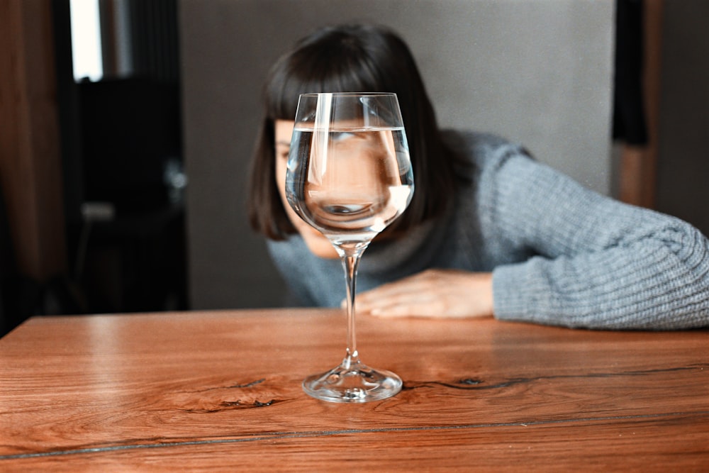 clear wine glass on brown wooden table