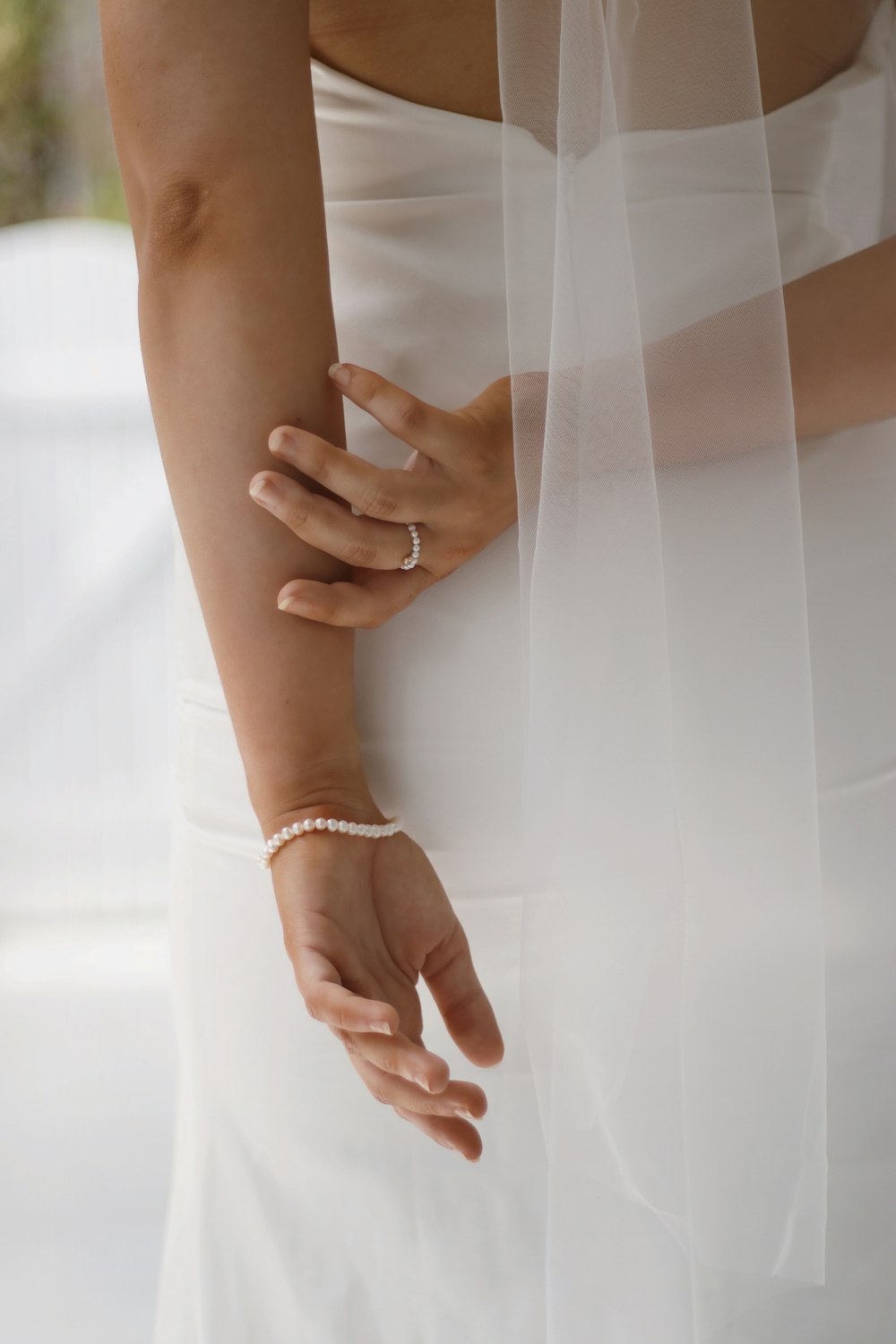 woman in white wedding dress wearing gold bracelet