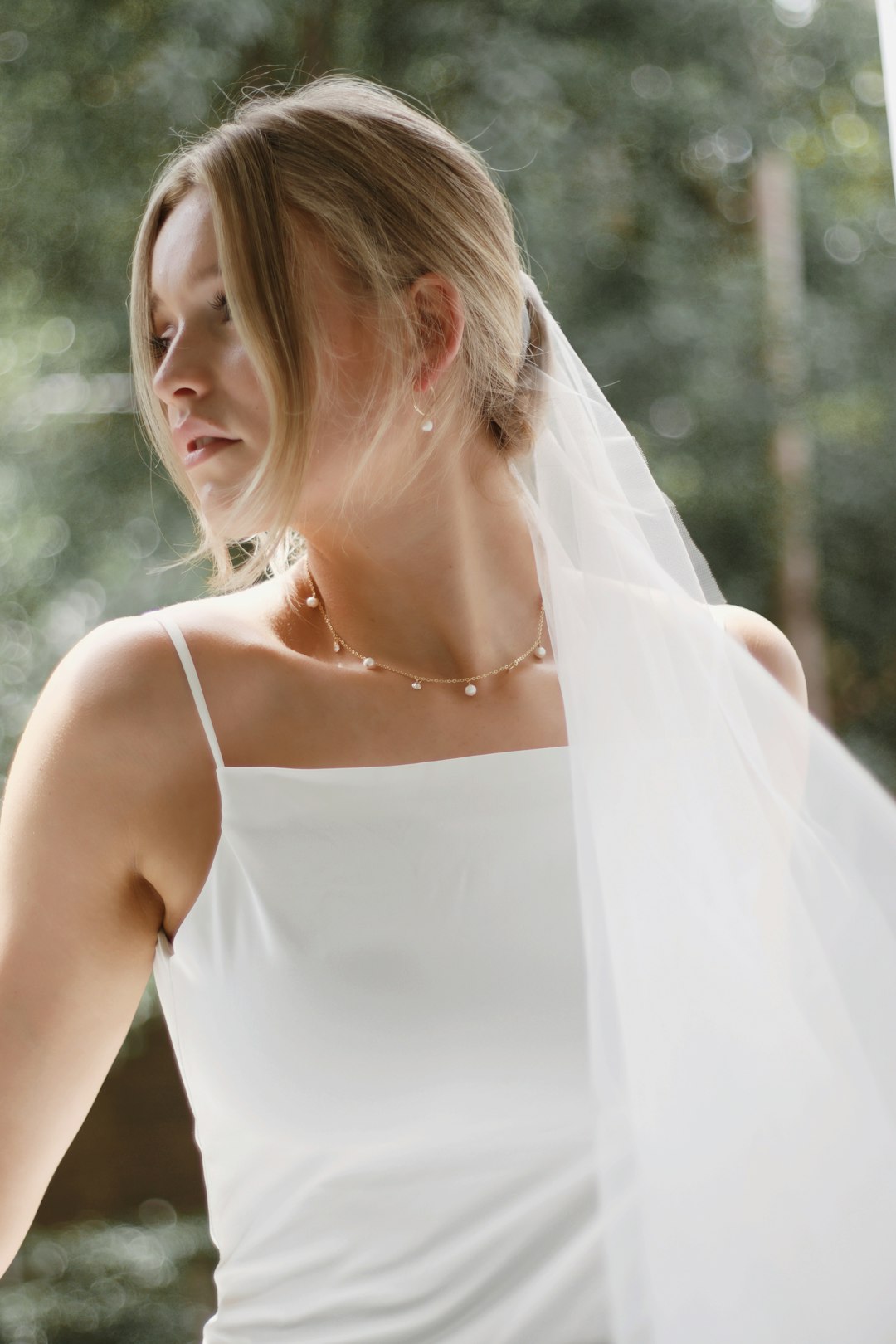 woman in white spaghetti strap dress