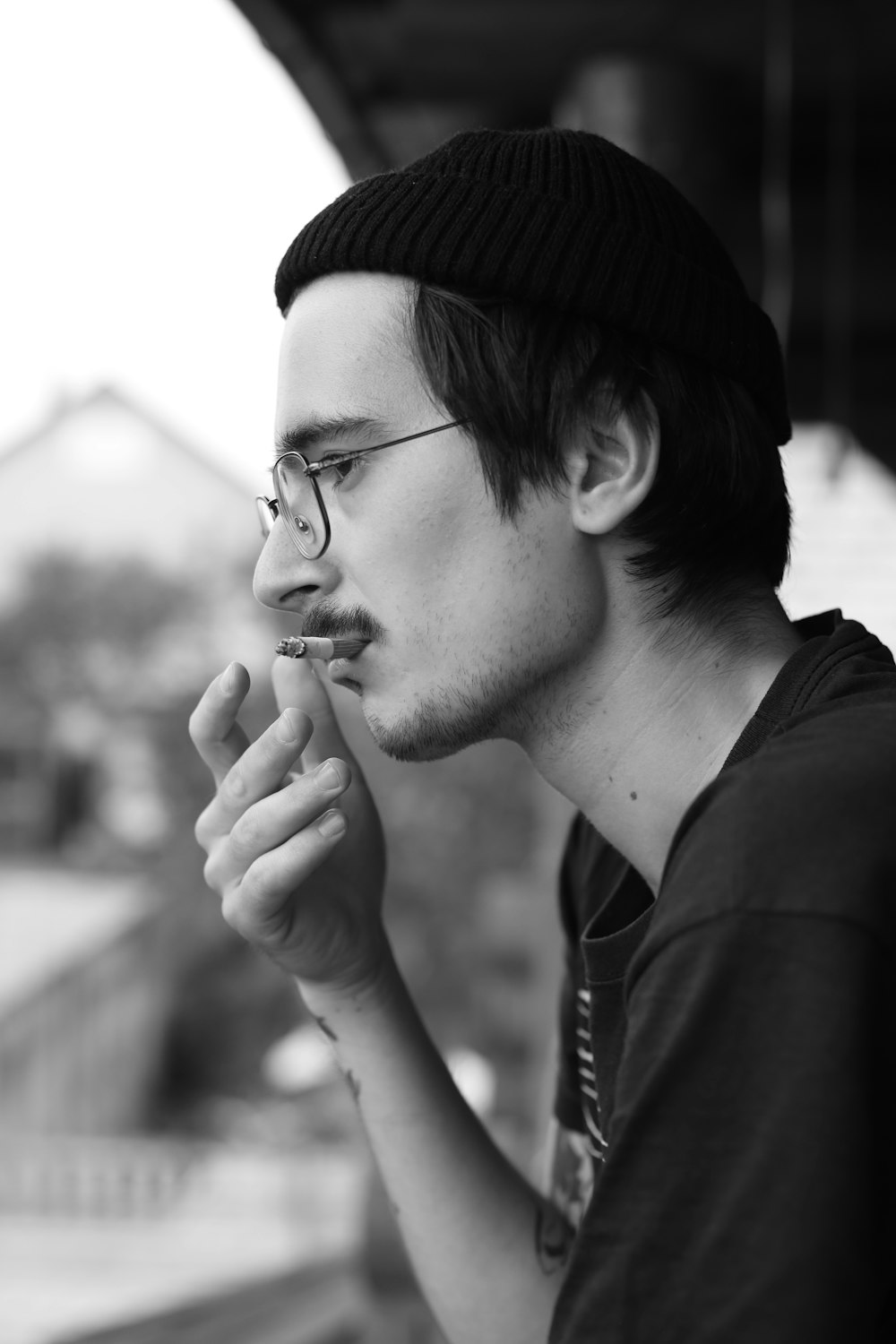 man in black knit cap and black framed eyeglasses