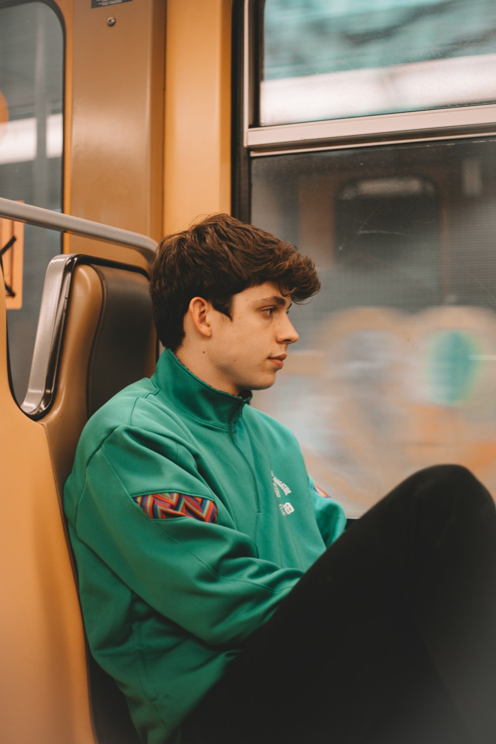 boy in blue hoodie sitting on chair