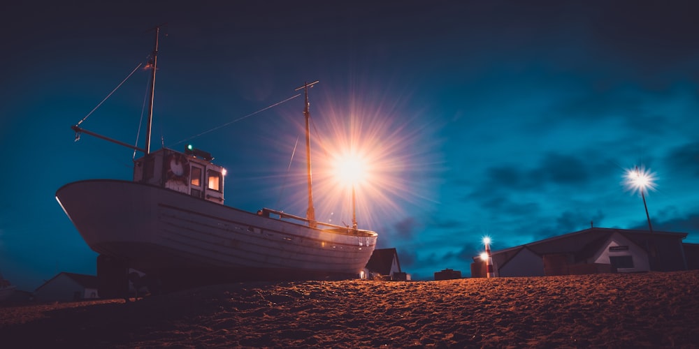 white and black boat on the beach during daytime