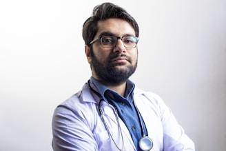man in white dress shirt wearing black framed eyeglasses