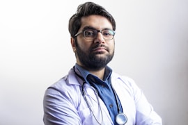 man in white dress shirt wearing black framed eyeglasses