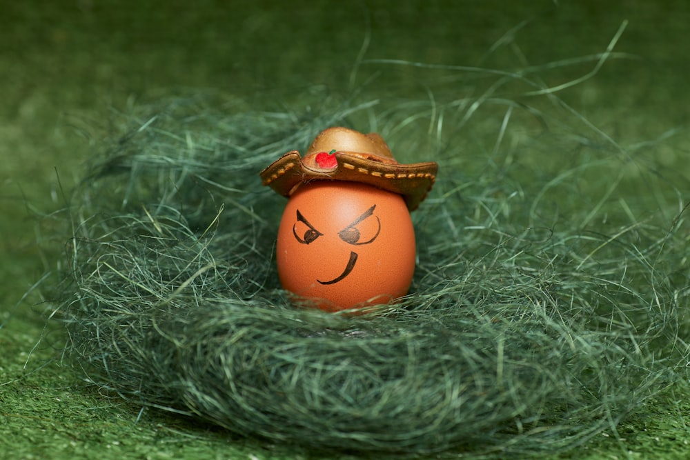 orange and yellow plastic toy on green fur textile