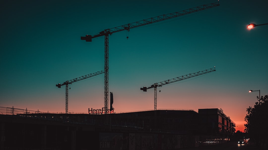 yellow crane under blue sky during daytime