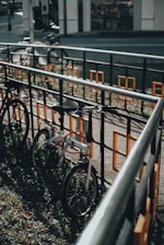 A cyclist locking their bike in a well-lit parking area.