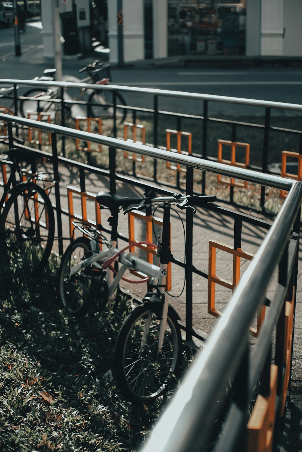 black and gray bicycle on gray metal railings