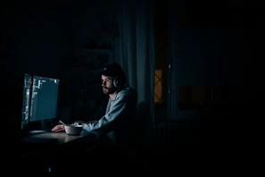 Coffee-fueled late-night coding session with a focused developer at a desk