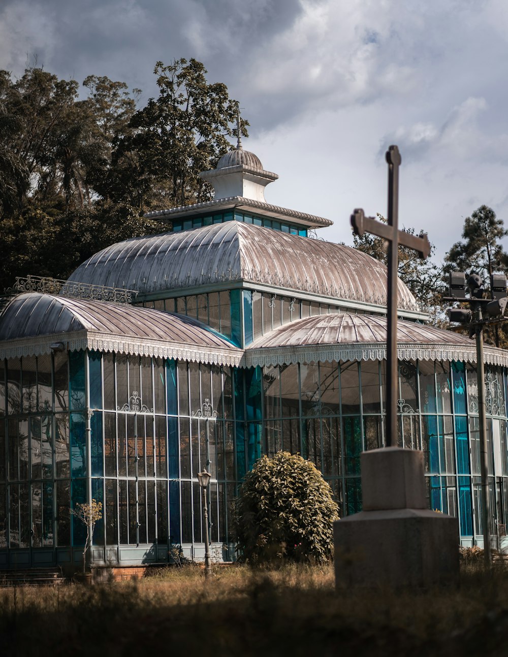 green and white gazebo near green trees during daytime