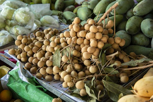 brown round fruits on brown wooden crate