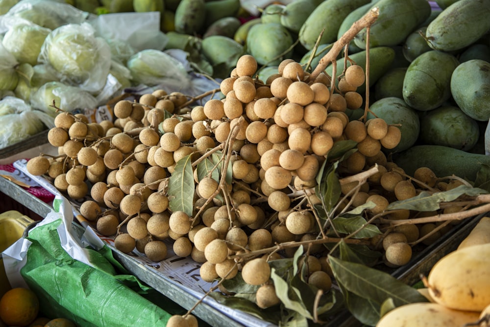 brown round fruits on brown wooden crate