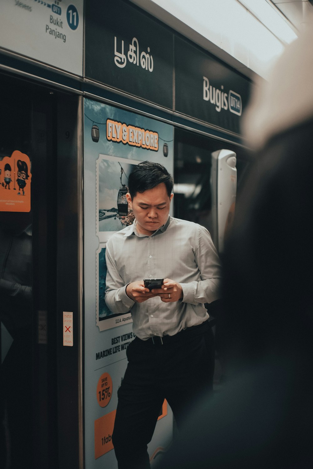 man in white dress shirt and black pants holding black dslr camera